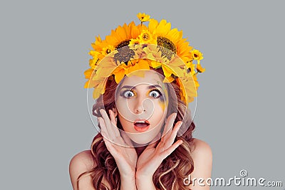 Woman with floral headband looking at camera in shock Stock Photo
