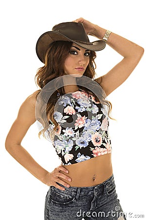 Woman in floral shirt cowgirl hand on hat Stock Photo