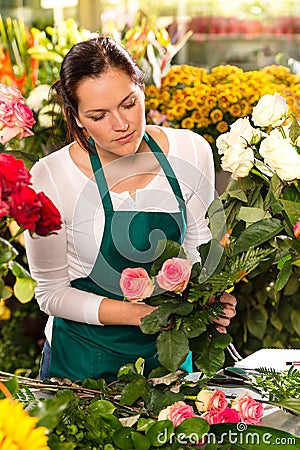 Woman florist preparing bouquet flowers shop retail Stock Photo