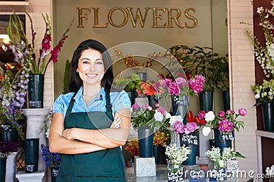 Woman florist standing outside shop Stock Photo