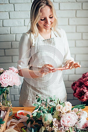 Florist photographing bouquet at phone. Mibile photography Stock Photo