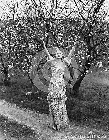 Woman with flowering trees Stock Photo