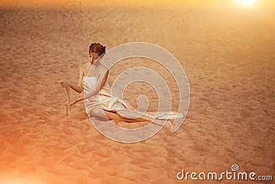 Woman in flying gold cloth Stock Photo