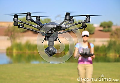 Woman Flying High-Tech Camera Drone (Large File) Stock Photo