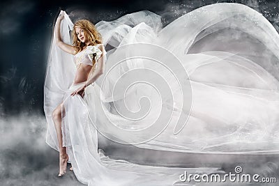 Woman with flying white fabric Stock Photo