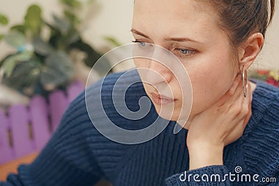 The woman focused gaze holds his neck, Stock Photo