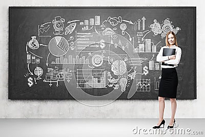 Woman with a folder and drawings on a chalkboard Stock Photo