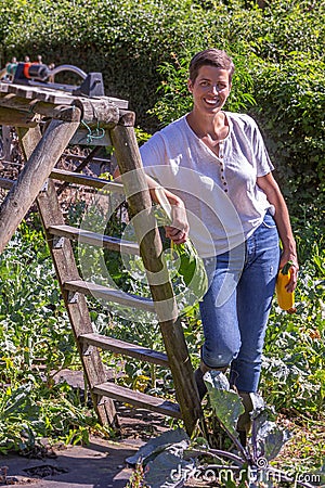 Woman on foot, picling in a vegetable garden Stock Photo
