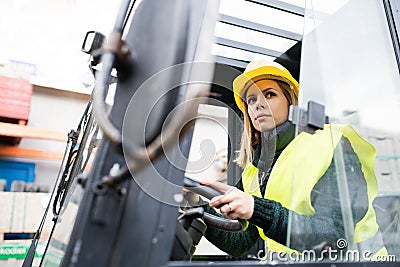 Woman forklift truck driver in an industrial area. Stock Photo