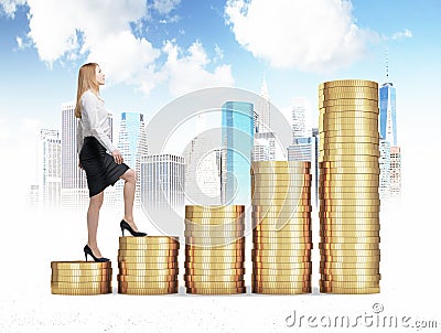 A woman in formal clothes is going up through a stairs which are made of golden coins. A concept of success. Stock Photo