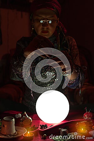 Woman fortune teller doing sorcery Stock Photo