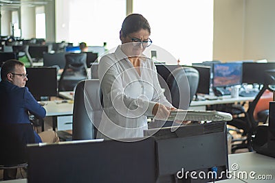 A woman freaks out and gets depressed from a mistake and breaks the keyboard on the monitor. Female manager gets angry Stock Photo