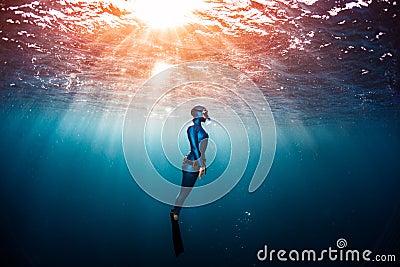 Woman free diver ascending from the depth Stock Photo