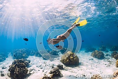 Woman freediver swimming over with yellow fins in ocean. Freediving or snorkeling in Mauritius Stock Photo