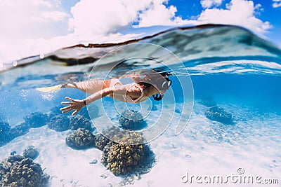 Woman freediver swimming over with yellow fins in ocean. Freediving or snorkeling in Mauritius Stock Photo