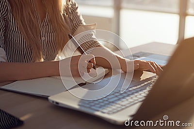 Woman freelancer female hands with pen writing on notebook at home or office Stock Photo