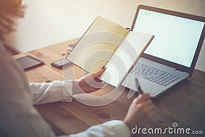 Woman freelancer working at home telework taking notes. Stock Photo