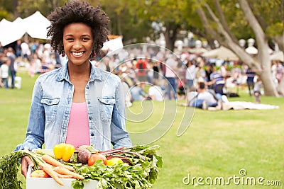 Woman With Fresh Produce Bought At Outdoor Farmers Market Stock Photo