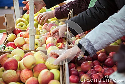 woman in the fruit market with apple in hand. fruits and vegetables. a lot of fruits. market. store. healthy food. Stock Photo