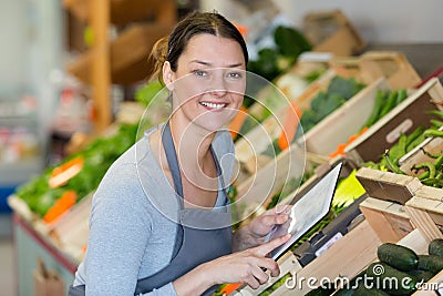 Woman fruit seller offers in shop Stock Photo