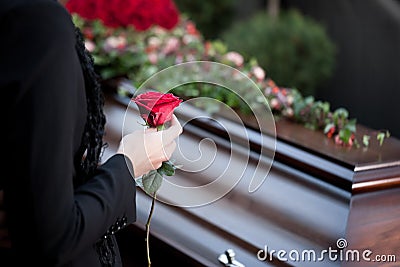 Woman at Funeral with coffin Stock Photo