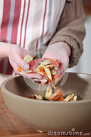 Woman gathering vegetable peelings Stock Photo