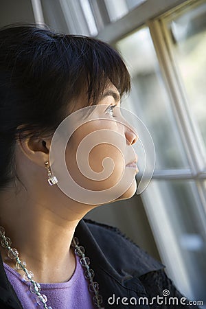 Woman gazing out window. Stock Photo