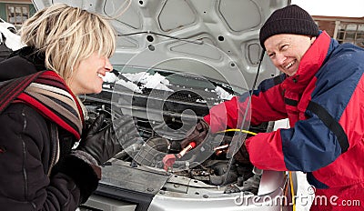 Woman getting a boost for her car Stock Photo