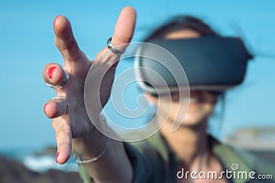 Woman getting experience using VR-headset glasses. Digital future and innovation. Visual reality concept. Woman with glasses of Stock Photo