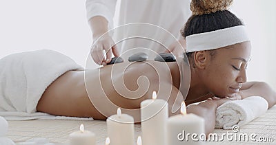 Woman Getting Hot Stone Massage Stock Photo