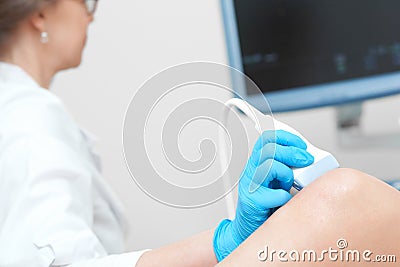 Woman getting knee ultrasound scanning examination at the clinic Stock Photo