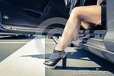 Woman getting out the car. Stock Photo