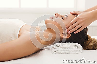 Woman getting professional facial massage at spa salon Stock Photo