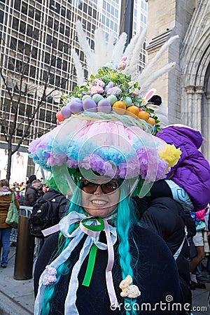 Woman in giant Easter egg hat and blue wig in the Easter Bonnet Parade Editorial Stock Photo