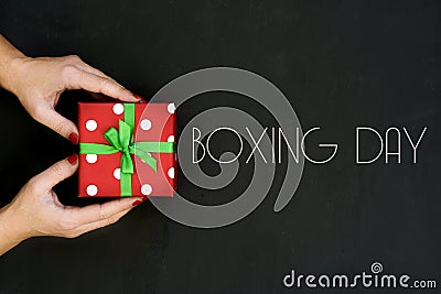 Woman with a gift and text boxing day Stock Photo