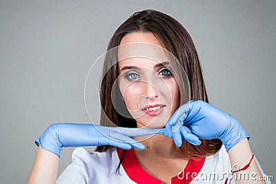 Woman or girl nurse or doctor in medical smock is smiling and pu Stock Photo