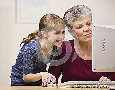 Woman and Girl Using Computer Stock Photo
