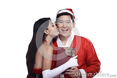 Woman give kiss to man in santa claus costume Stock Photo