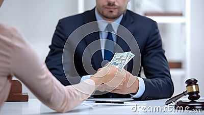 Woman giving bribe to corrupt lawyer, document falsification in illegal business Stock Photo