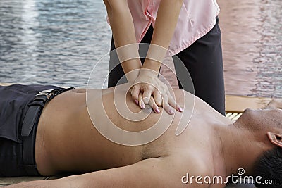 Woman giving CPR to drowning man, CPR life saving Stock Photo