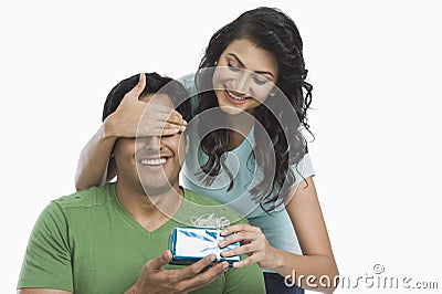 Woman giving a gift to her husband Stock Photo