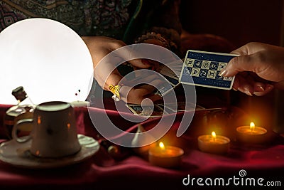 Woman giving a tarot card to fortune teller woman Stock Photo