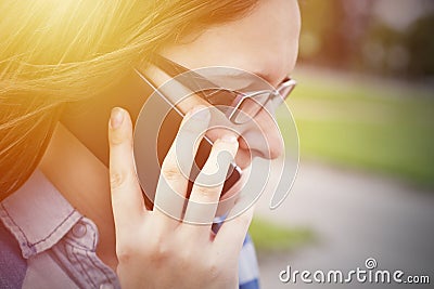 Woman in glasses close up portrait with phone Stock Photo