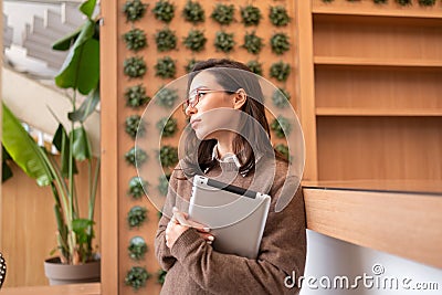 Woman standing holding digital tablet Stock Photo