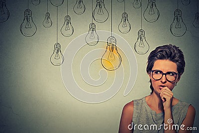 Woman with glasses thinking hard looking for right solution Stock Photo