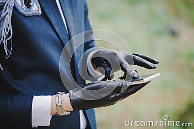 Woman in gloves uses smartphone Stock Photo