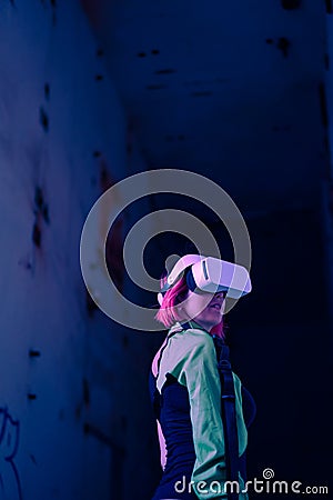 Woman goes into virtual reality using virtual reality headset. Stock Photo