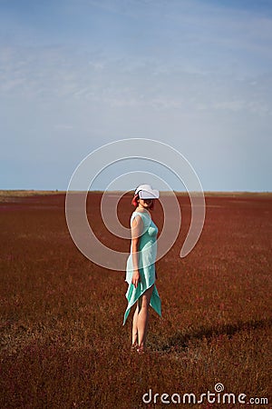 Woman goes into virtual reality using virtual reality headset. Stock Photo