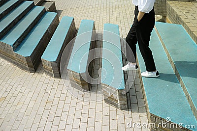 A woman going across steps with a gap in them Stock Photo