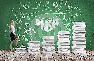 A woman is going up using a stairs which are made of white books to reach graduation hat Stock Photo